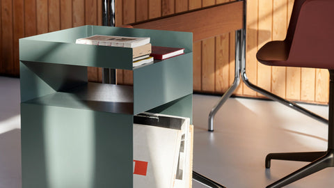 Rotate SC73 by Space Copenhagen for &Tradition in hunter green powder-coated steel, styled as an office trolley with books and magazines