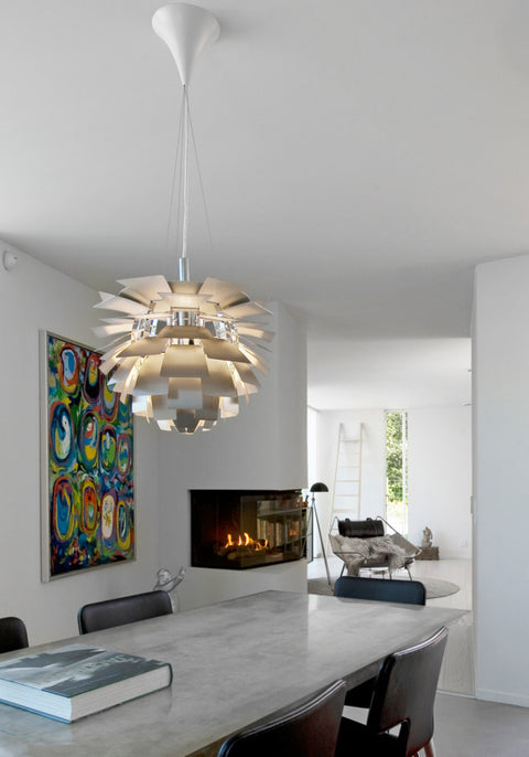 PH Artichoke pendant by Louis Poulsen over a modern dining table in a Scandinavian home interior
