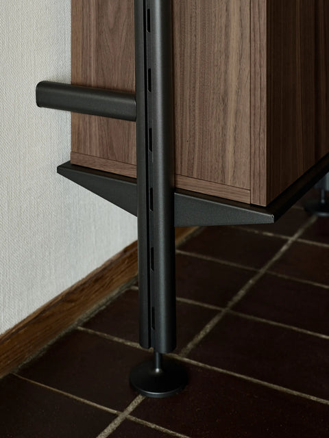 String Furniture Pira Shelf and walnut cabinet detail, steel shelving with adjustable leg on a tiled floor