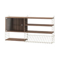 Beige Magazine Shelf Metal by String™ combined with walnut shelves and cabinet in Scandinavian modular shelving system.