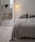 vl ring crown wall lamp 1 in brass and opal glass by louis poulsen above a bed