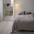 vl ring crown wall lamp 1 in brass and opal glass by louis poulsen above a bed