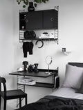 String Furniture Work Desk in black finish integrated into modular shelving system, Scandinavian bedroom vanity and workspace solution.