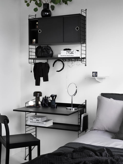 String Furniture Work Desk in black finish integrated into modular shelving system, Scandinavian bedroom vanity and workspace solution.