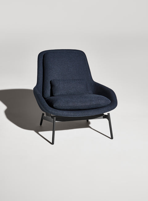 Blu Dot Field Lounge Chair in navy blue fabric with black sled base, shot straight-on against a neutral grey studio background