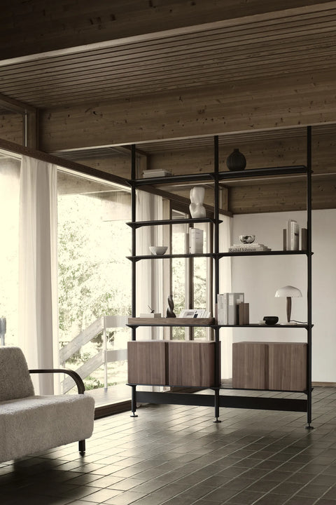 String Furniture Pira shelving in black grey with walnut cabinets, floor to ceiling steel shelving in a living room