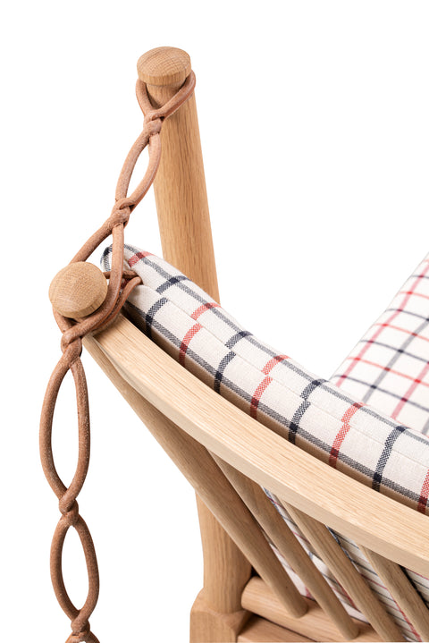 Leather strap chain and oak post detail on the checked cushion of the Fredericia Spokeback Sofa by Borge Mogensen