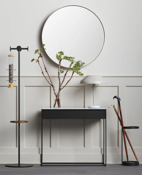 Blu Dot Construct 1 Drawer Console in Carrara marble and black powder-coated steel, styled in a modern entryway with a large round Hoopla mirror, branch arrangement in glass vase, and white dome table lamp
