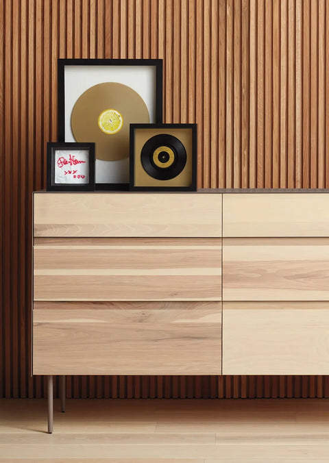 Blu Dot Clad 6 Drawer Dresser in Hickory/White styled against a warm wood slat wall in a modern bedroom