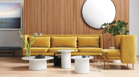 Blu Dot Bloke 95" Sofa with chaise in ochre velvet styled in a warm modern living room with wood slat wall