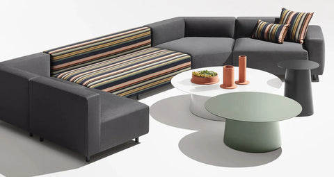 Circula Large Coffee Table by Blu Dot in White and Grey Green, styled in a living room setting with a sectional sofa