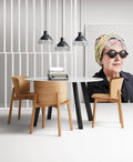 Blu Dot Buddy Chair in white oak styled around a round dining table in a modern dining room
