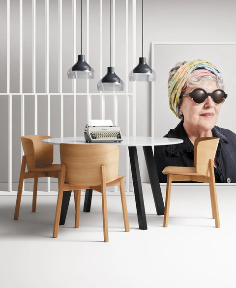 Blu Dot Buddy Chair in white oak styled around a round dining table in a modern dining room