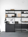 Black String™ organizers displayed on modular shelving system in home office with books and desk accessories