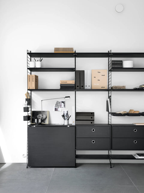 Black String™ organizers displayed on modular shelving system in home office with books and desk accessories