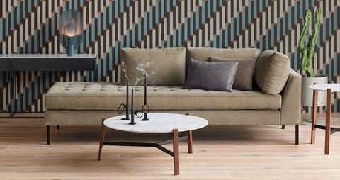 Blu Dot Free Range Coffee Table styled in a modern living room with a tan velvet daybed sofa and geometric patterned wallpaper