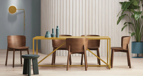 Blu Dot Buddy Chair in walnut styled around a yellow Strut dining table in a bright modern dining room