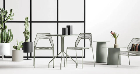 Plot Small Planter by Blu Dot in White and Oblivion, styled in an outdoor dining setting with Hot Mesh chairs and dining table