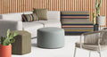 Plot Small Planter by Blu Dot in Oblivion, styled in an outdoor lounge setting with sofa and ottomans