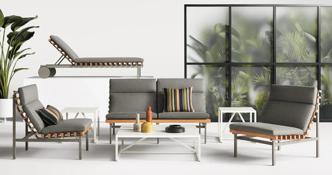 Perch Outdoor Lounge Chair by Blu Dot in Toohey Charcoal, styled with Perch 2 Seat Sofa, chaise, and side tables in a modern outdoor lounge setting