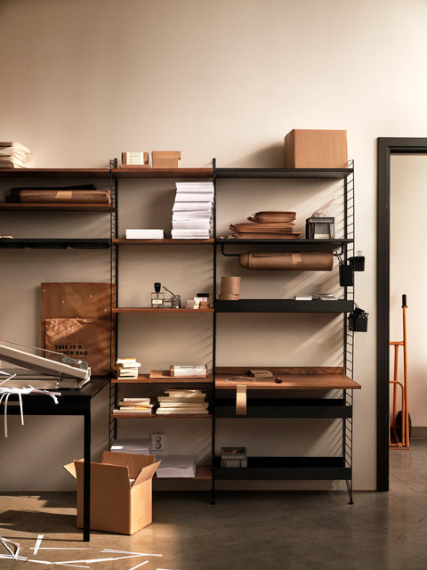 String Furniture Work Desk in walnut integrated into modular shelving system, Scandinavian workspace setup with shelves and storage.