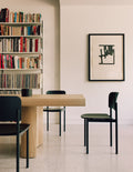 plan chair in a minimalist modern dining room, wood chair with metal legs by fredericia furniture