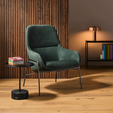 Modern lounge chair with black tulip coffee table and wood slat accent wall 