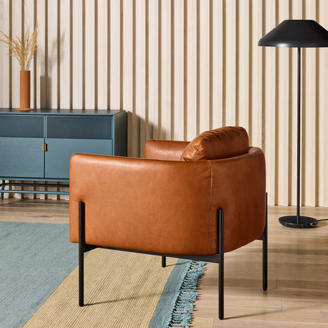 Blu Dot Get Up Lounge Chair in cognac leather with black steel frame styled in a modern living room
