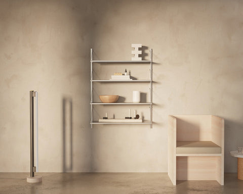 Frama Shelf Library Single Section in Stainless Steel, steel shelves with a bowl, books and objects beside a pale timber bench