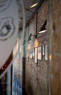 aj wall lamp by louis poulsen mounted on brick wall in restaurant 