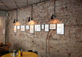 black aj wall lamp by louis poulsen on brick wall in restaurant 