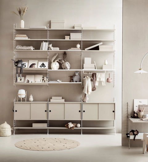 String Furniture beige modular shelving system with cabinets, Scandinavian wall storage for children's room