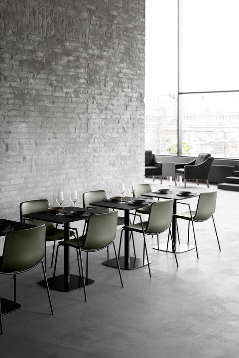 Set of green Pato Armchairs in a modern restaurant dining setting