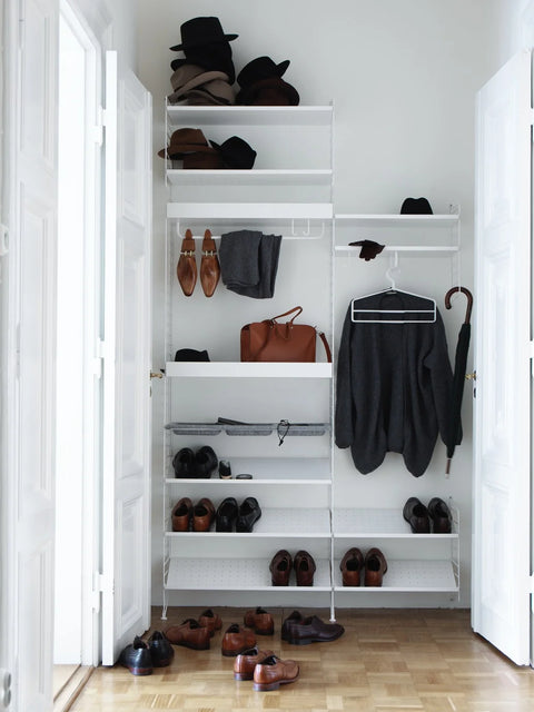 White String® System shoe shelves, 30.7"W, with modular wall storage in a Scandinavian entryway