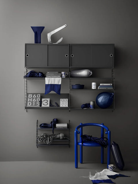 Dark Grey String® System wall panels 19.7"H x 11.8"D with shelves and cabinets styled in a modern grey interior