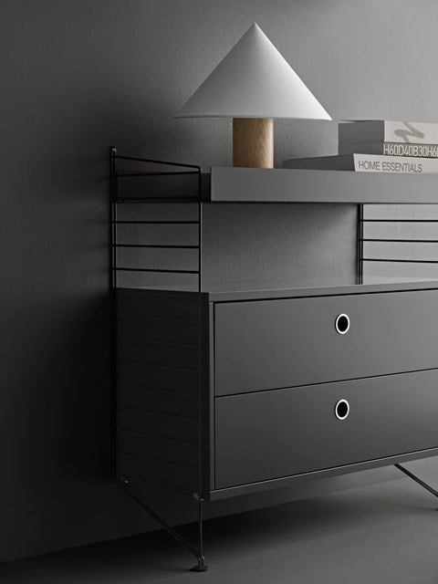 Black String® System chest of drawers with two drawers styled under shelves with modern lighting and decor