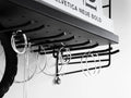 Close-up of String® Hanger Rack in black mounted under shelf holding jewelry and accessories