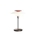 PH 80 Portable Lamp in chrome with red top reflector illuminated on black background by Louis Poulsen