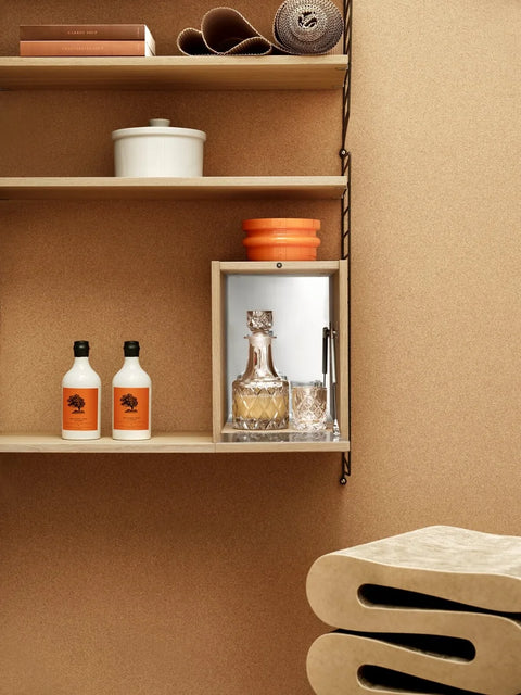 String® System Tiny Cabinet in oak with mirrored door, styled as a mini bar within modular shelving