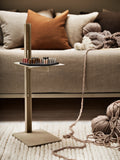 Museum Side Table in beige placed in living room with sofa and yarn accessories