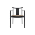 Audo Copenhagen Merkur Dining Chair w/ Armrests in Black Oak with Logan Flint seat, packshot on white