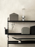 Black String® System shelving with stainless steel J-hooks holding scissors and accessories