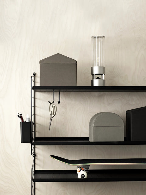 Black String® System shelving with stainless steel J-hooks holding scissors and accessories