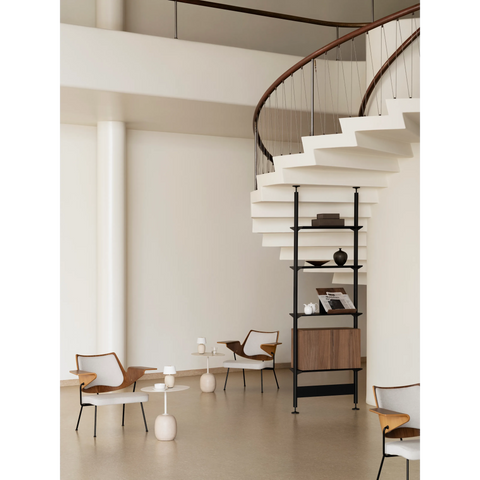 String Furniture Pira freestanding shelving in black grey with a walnut magazine shelf in a bright space