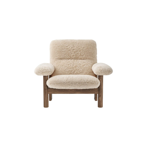 Audo Copenhagen Brasilia Lounge Chair in Walnut and Sheepskin Natural, packshot on white