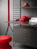 String Furniture Work Desk in grey finish within modular shelving system, styled with red retro phone and modern Scandinavian storage.