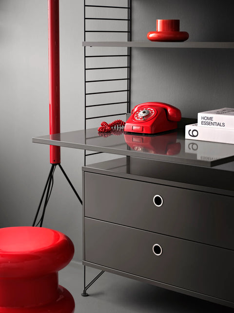 String Furniture Work Desk in grey finish within modular shelving system, styled with red retro phone and modern Scandinavian storage.