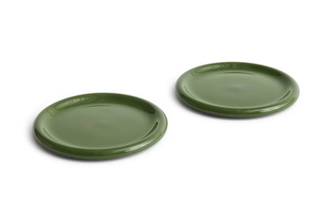HAY Barro Plates, Ø24, Green, glazed terracotta dinner plates in olive green, two shown at an angle on plain white