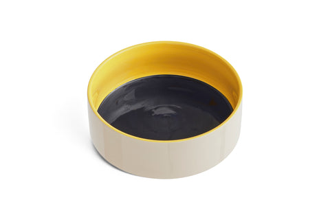 HAY Dog Bowl, Large, Blue and Yellow, glazed ceramic pet bowl, off-white outside with a yellow rim and navy blue interior on a plain white background