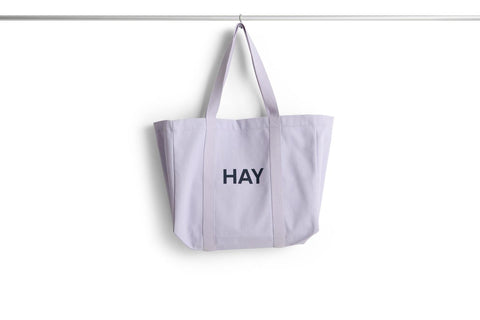 HAY Shopper Bag, Lavender, cotton tote bag, pale lilac shopper hanging from a rail against a plain white background